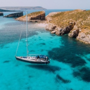 Aerial of Yacht in Blue Lagoon, off Comino