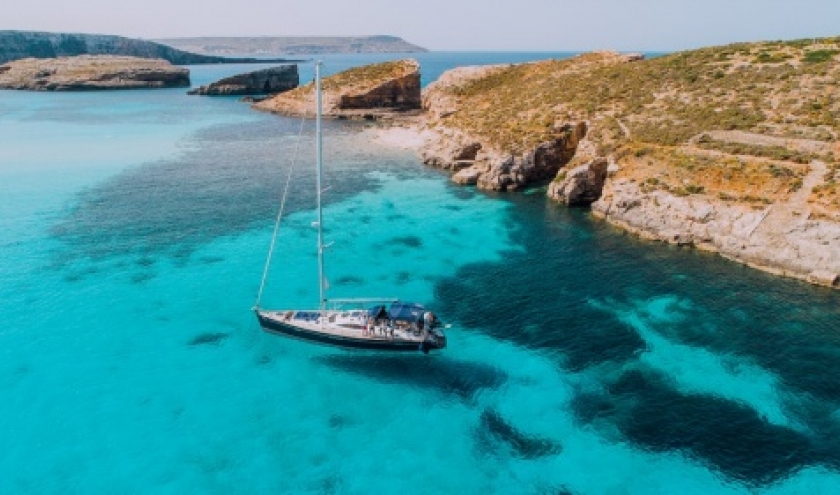 Aerial of Yacht in Blue Lagoon, off Comino